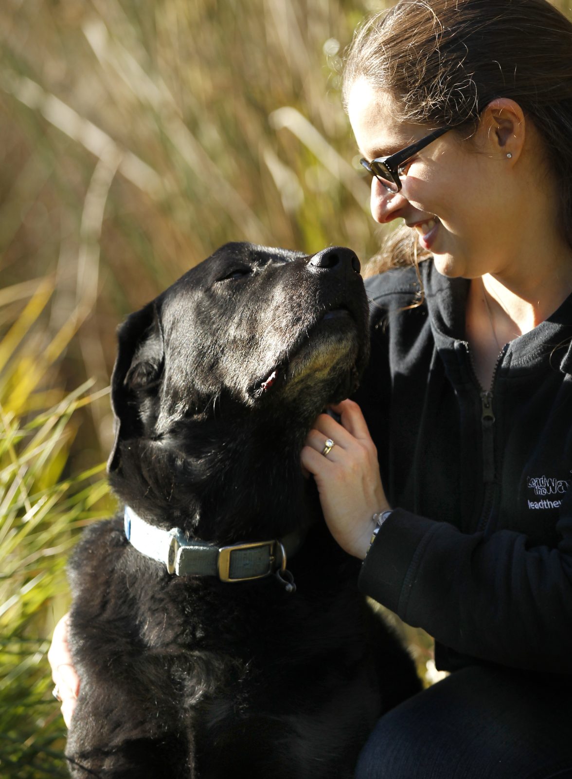 Melanie bonding with Therapy Dog Tarly. Melanie and Tarly gaze into each other's eyes.